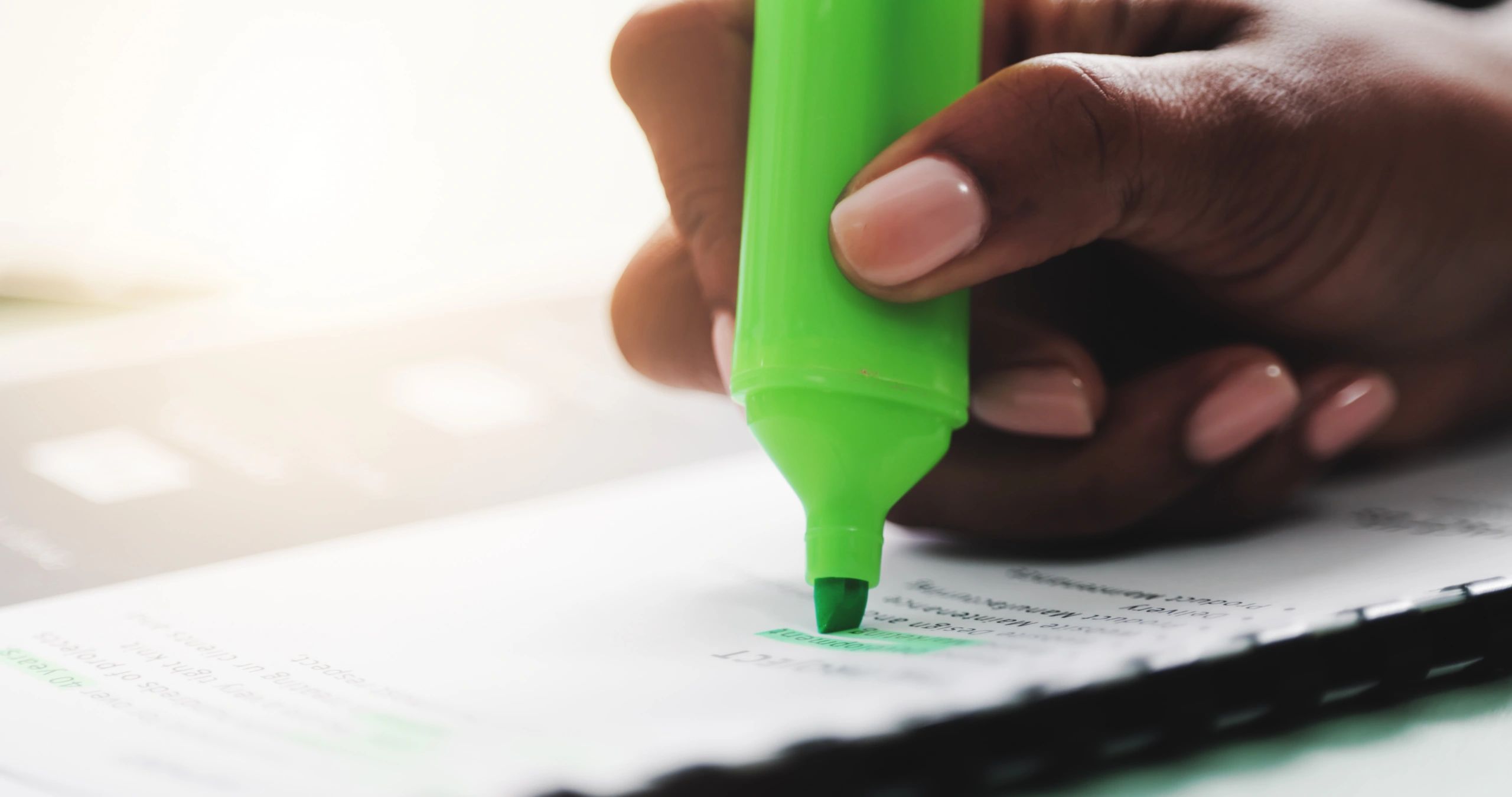 Hands highlighting a printed document